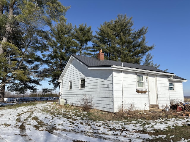 view of snow covered exterior featuring cooling unit