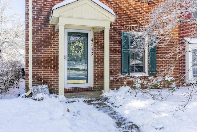 view of snow covered property entrance