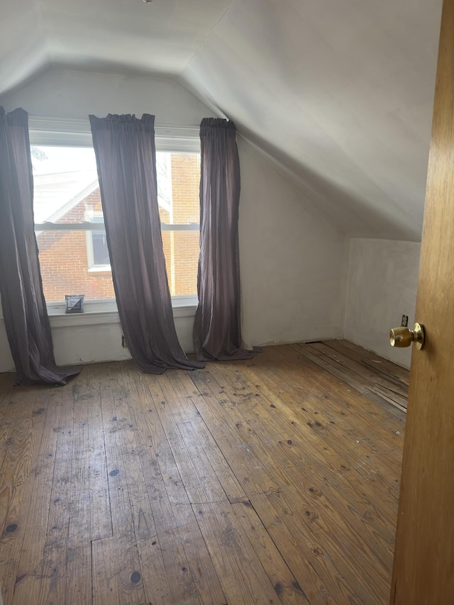 bonus room with wood-type flooring and lofted ceiling