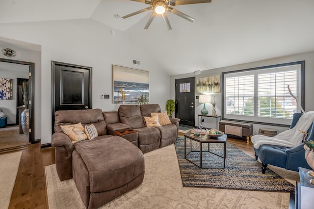 living room with wood-type flooring, ceiling fan, and lofted ceiling