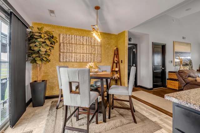 dining area with plenty of natural light and vaulted ceiling