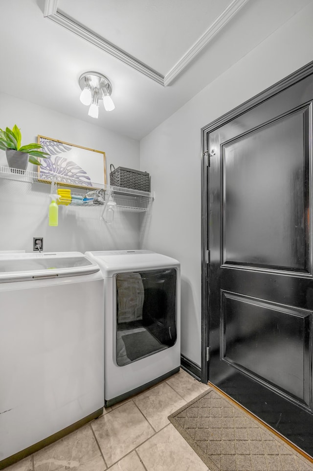 washroom featuring washer and dryer and light tile patterned floors