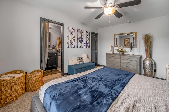 bedroom featuring ceiling fan, ensuite bathroom, and light carpet