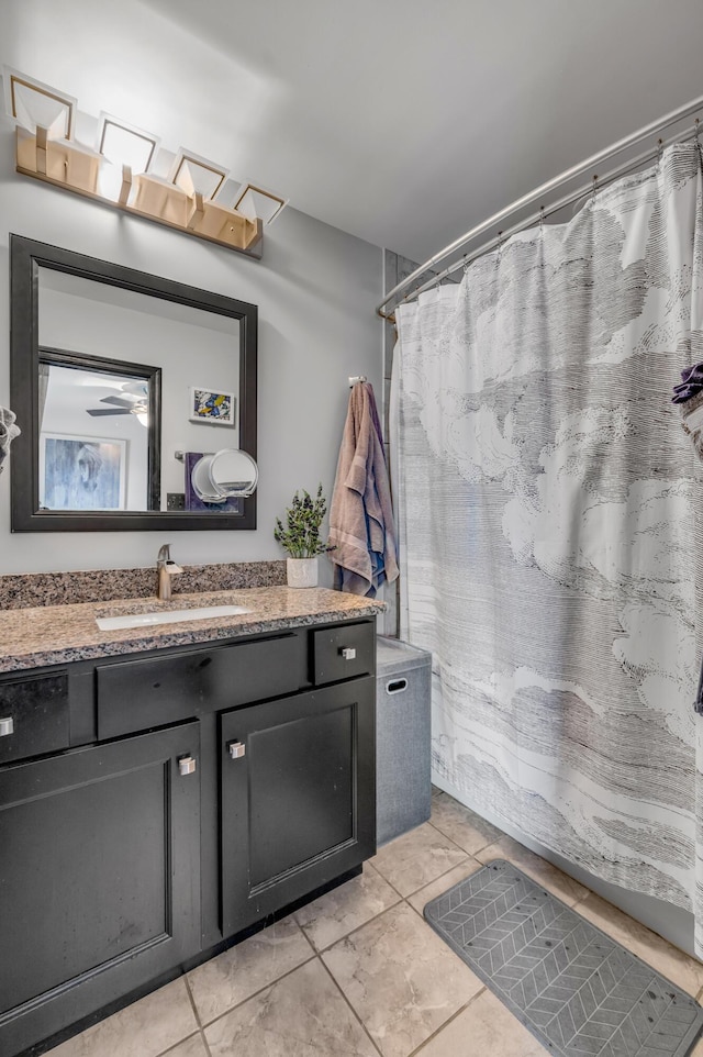 bathroom with ceiling fan, tile patterned flooring, and vanity