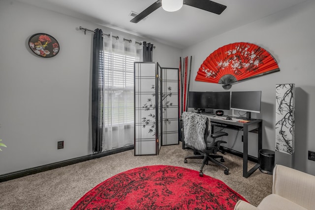 carpeted office space featuring ceiling fan