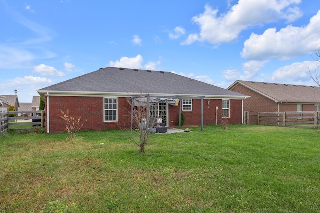 back of property featuring a yard