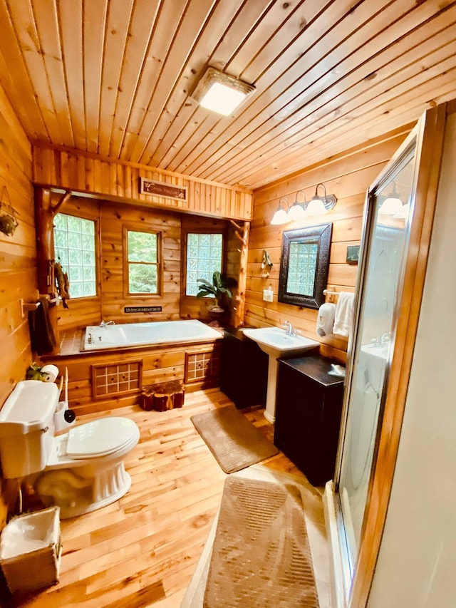 bathroom featuring wood-type flooring, wood ceiling, wooden walls, and plus walk in shower