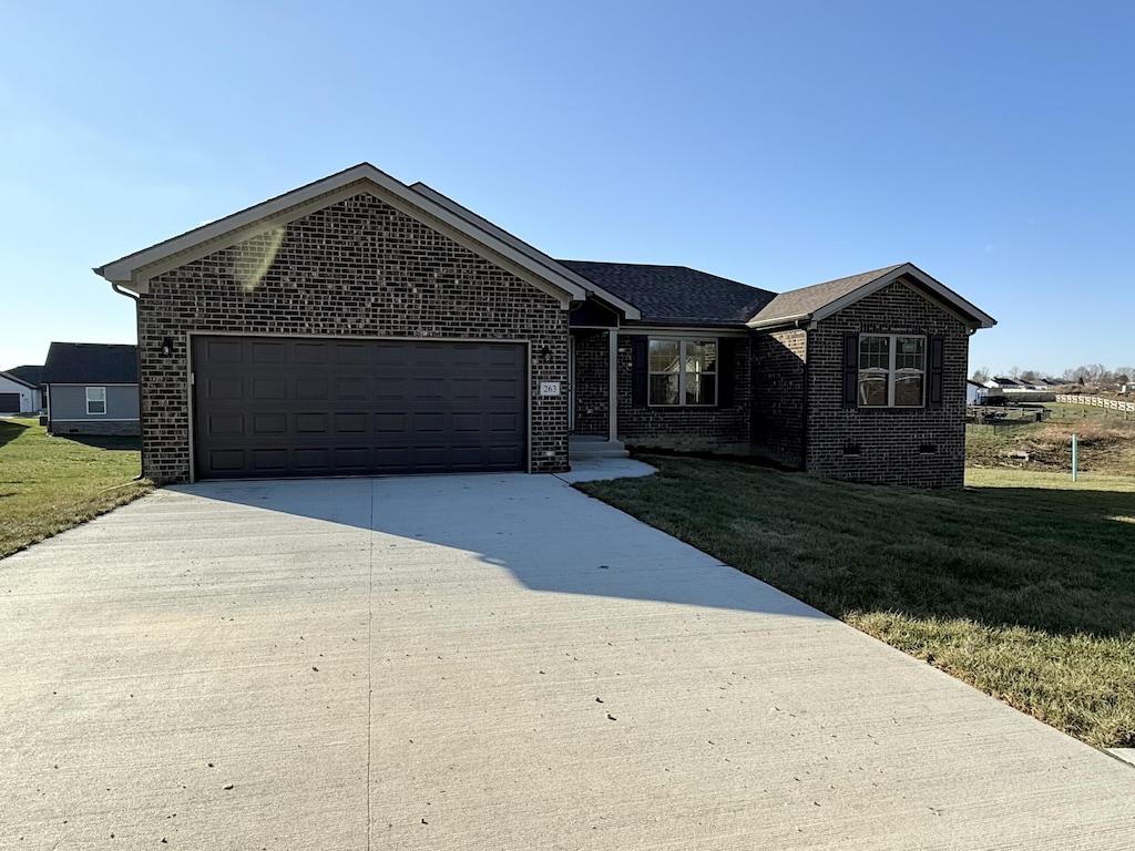 single story home with a garage and a front yard