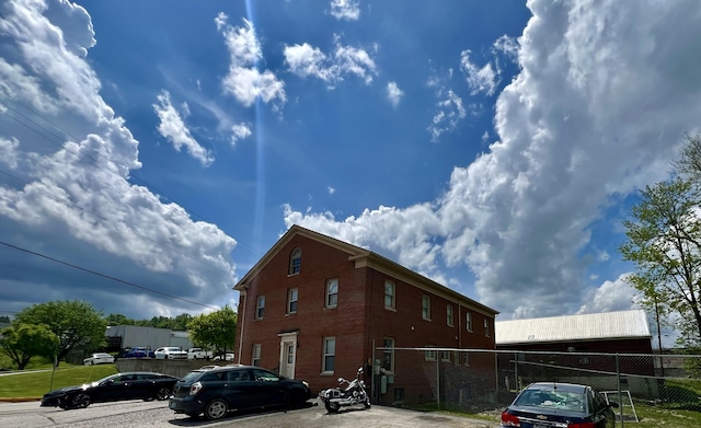 240 E Main St, Mount Vernon, KY 40456 - view of side of home featuring fence and brick siding