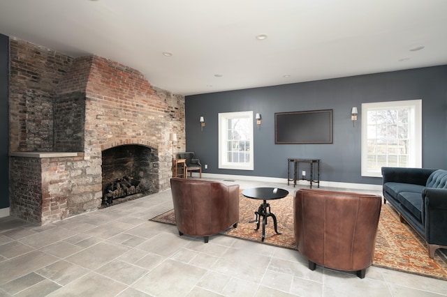 living room featuring a brick fireplace