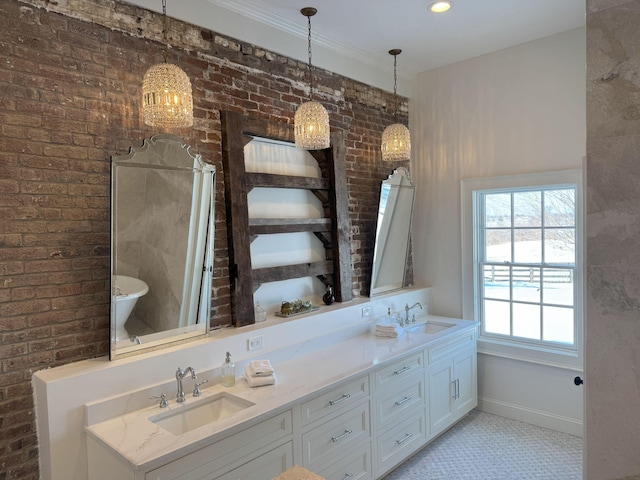 bathroom featuring tile patterned floors, a bathtub, vanity, and brick wall