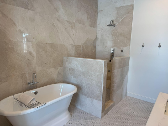 bathroom featuring tile patterned floors, tile walls, and independent shower and bath