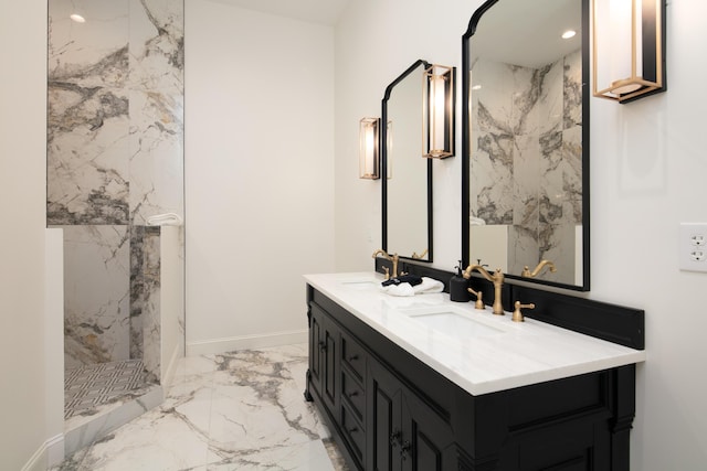 bathroom featuring tiled shower and vanity