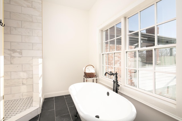 bathroom with tile patterned flooring and a bathtub