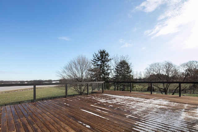 wooden deck with a rural view and a yard