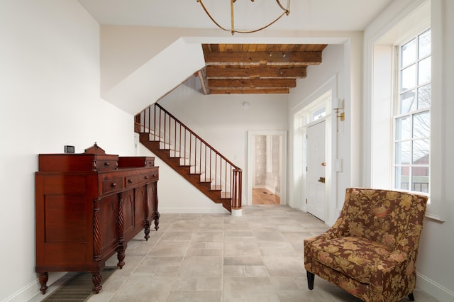 foyer entrance with beam ceiling and wood ceiling