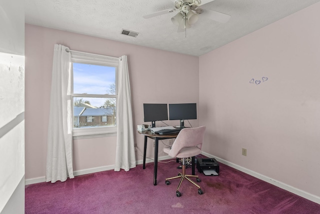 carpeted office space featuring a textured ceiling and ceiling fan