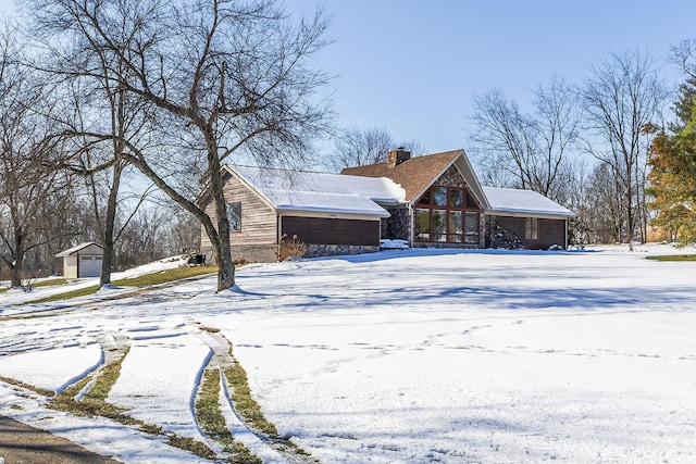 view of snow covered exterior featuring a garage