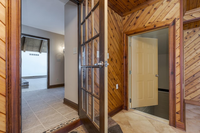 hall featuring wooden walls