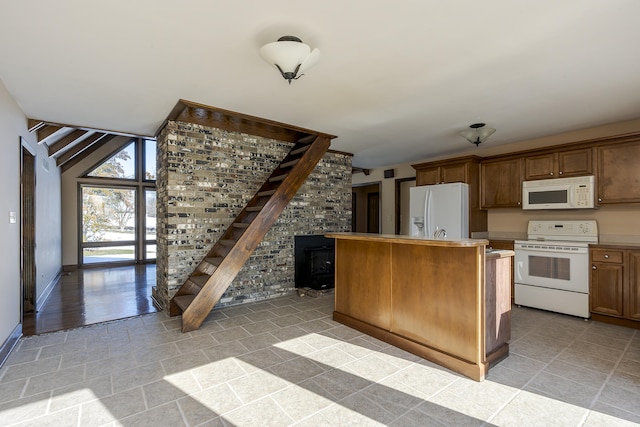 kitchen featuring white appliances, vaulted ceiling, and a kitchen island