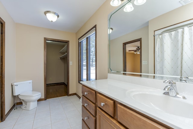 bathroom with ceiling fan, toilet, vanity, and tile patterned flooring