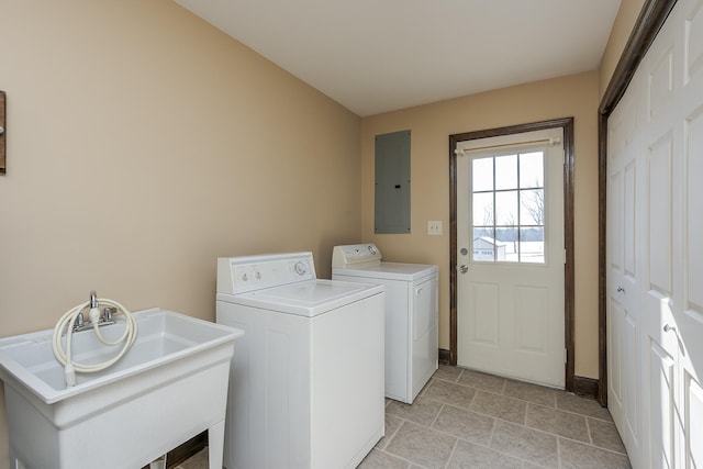 laundry area featuring washer and clothes dryer, sink, and electric panel