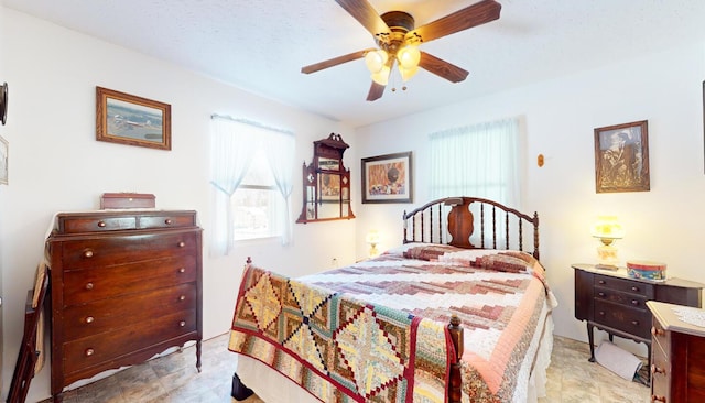 bedroom with a textured ceiling and ceiling fan