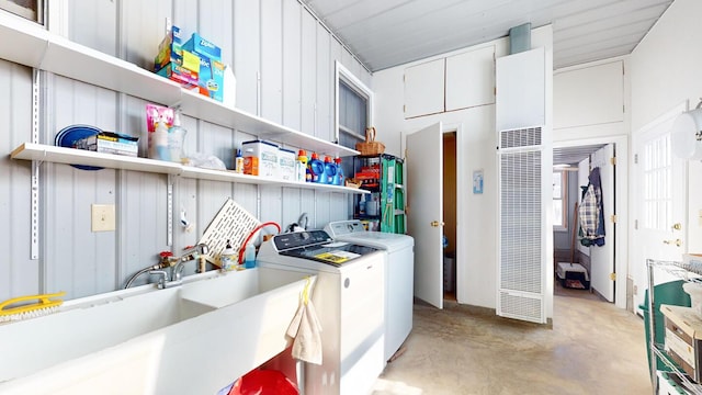 washroom with separate washer and dryer and sink