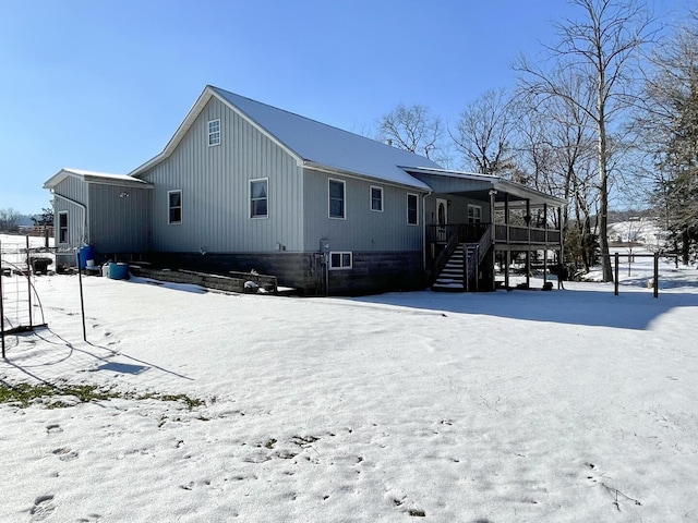 view of snow covered rear of property