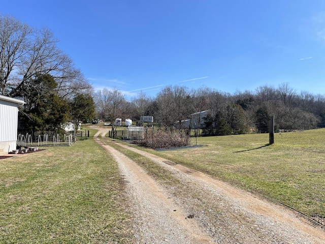 view of side of property featuring a rural view and a yard