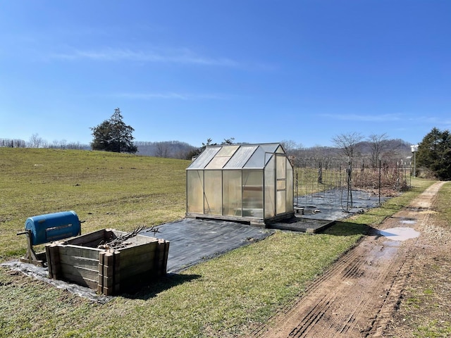 view of outbuilding featuring a yard and a rural view