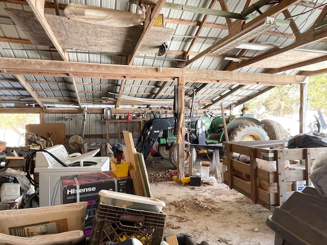 miscellaneous room featuring plenty of natural light, concrete floors, and vaulted ceiling