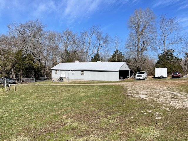 exterior space featuring an outdoor structure and a front yard