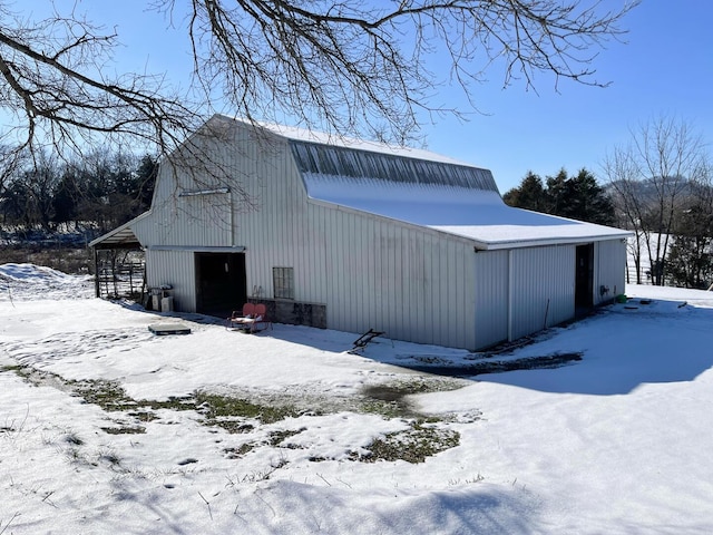 view of snowy exterior featuring an outdoor structure