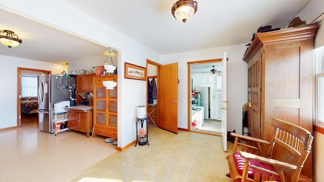 interior space featuring stainless steel fridge and ceiling fan