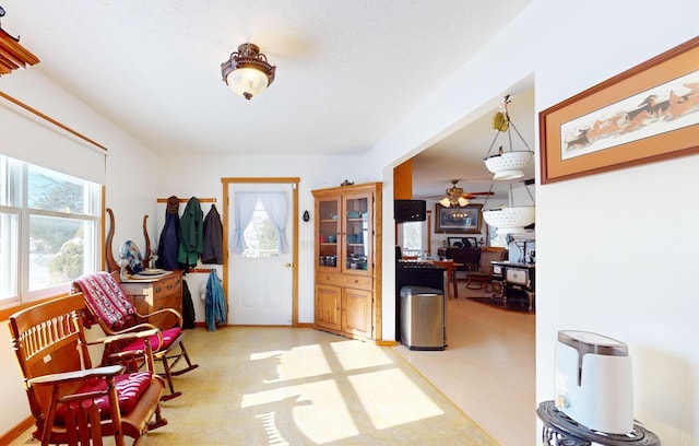 entrance foyer featuring ceiling fan and plenty of natural light