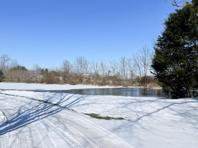 snowy yard with a water view