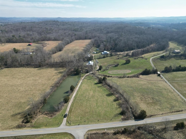 birds eye view of property featuring a water view and a rural view