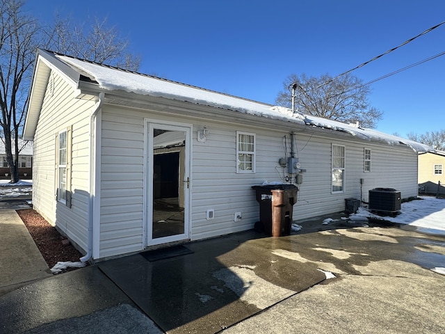 rear view of property featuring a patio and central AC