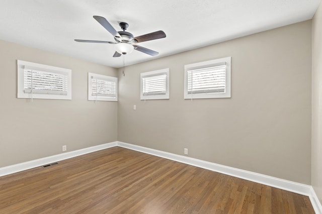 spare room with hardwood / wood-style flooring and plenty of natural light