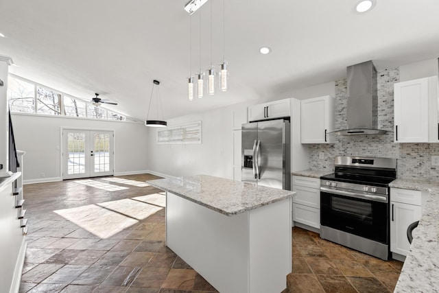 kitchen with a center island, stainless steel appliances, white cabinetry, and wall chimney exhaust hood