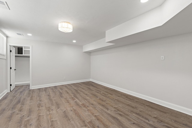 basement with hardwood / wood-style flooring