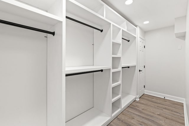 walk in closet with hardwood / wood-style floors