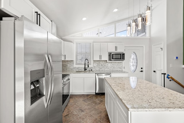 kitchen featuring white cabinetry, sink, tasteful backsplash, decorative light fixtures, and appliances with stainless steel finishes