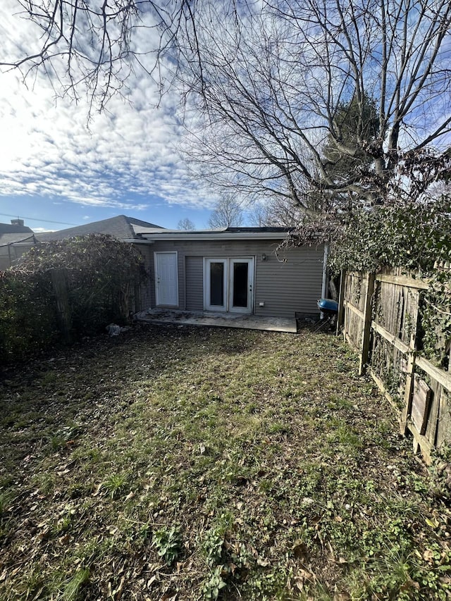 back of house with a yard and a patio area