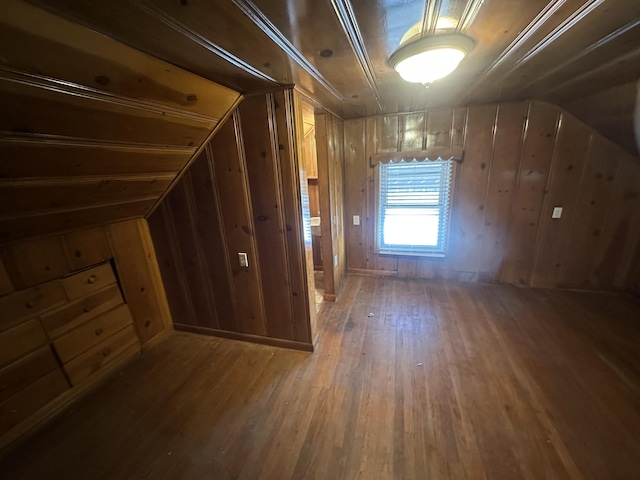 bonus room featuring vaulted ceiling, hardwood / wood-style floors, and wood walls