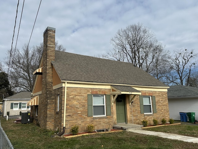 view of front of home featuring a front yard and central air condition unit