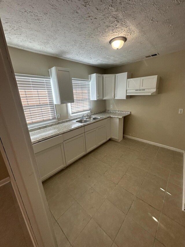 spare room with ceiling fan, hardwood / wood-style floors, and a textured ceiling