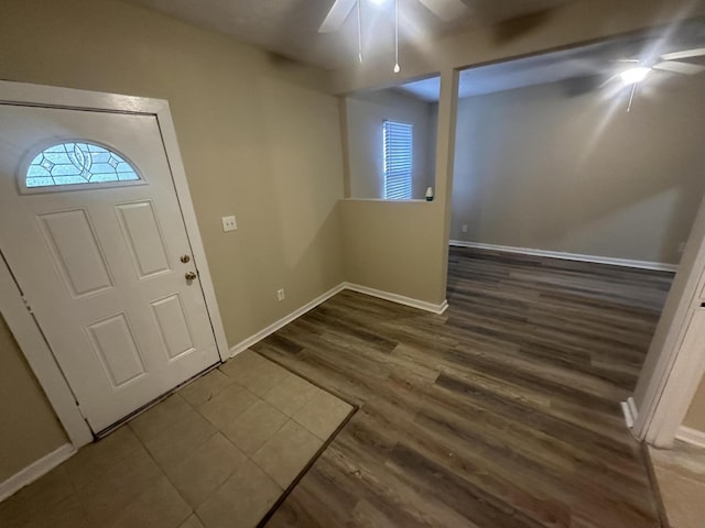 entryway with wood finished floors, baseboards, and ceiling fan