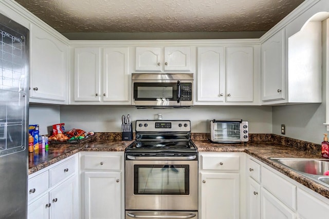 kitchen with white cabinetry, sink, and appliances with stainless steel finishes